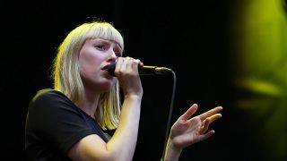 Sängerin Lea singt vor einem schwarzen Hintergrund in ein Mikro. (Quelle: imago images/Hartenfelser)